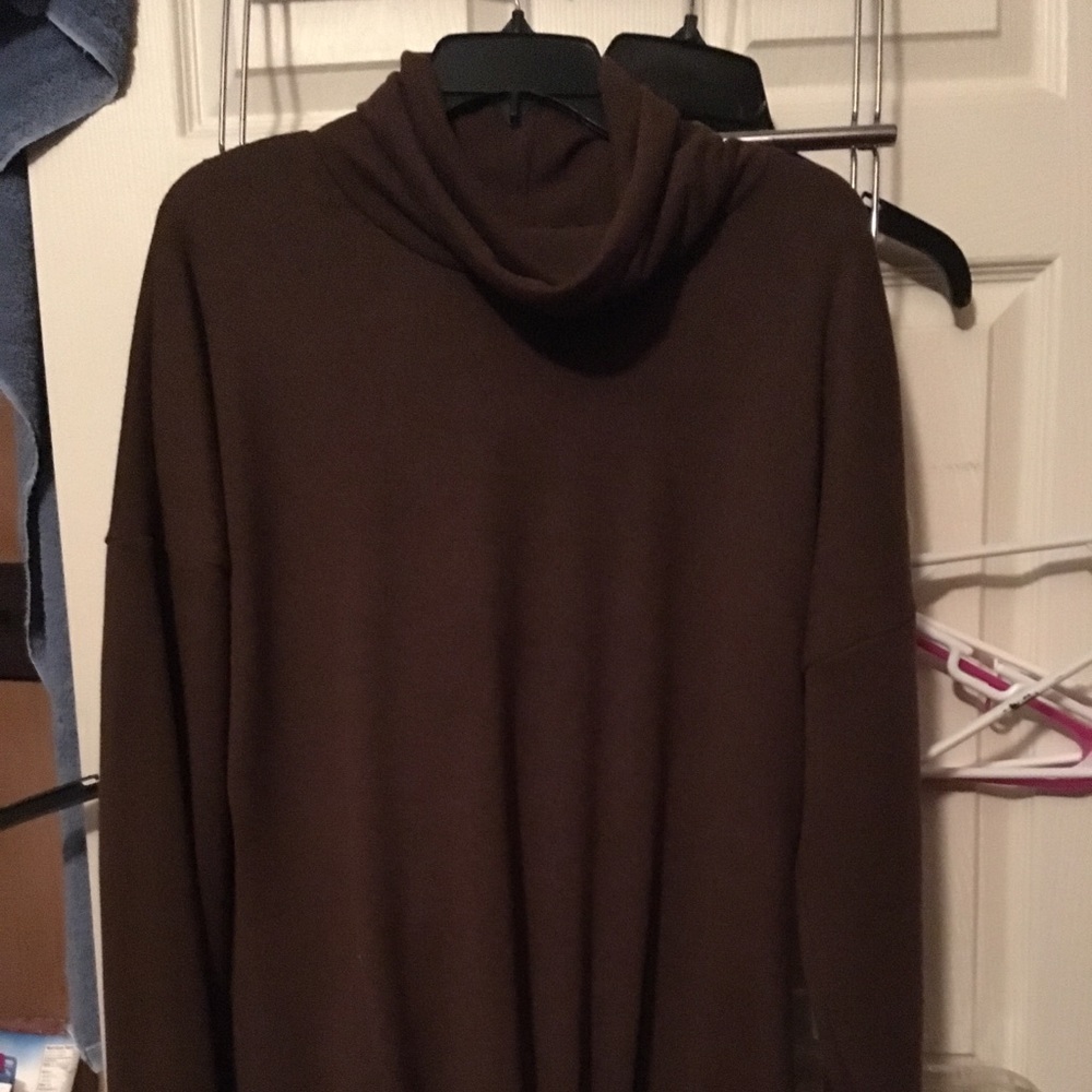 Tunic length turtleneck sweater with tie knot